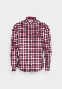Röd och marinblå rutig långärmad skjorta med knapp-ner krage, med vita detaljer och en liten logotyp på bröstet. Klädd i bomull.