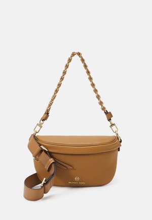 Sac à main Michael Kors en cuir fauve avec un dessus incurvé, une anse chaîne dorée et une bandoulière ajustable posé sur un fond blanc.