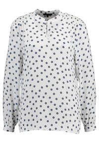 White blouse with navy polka dots, round neckline, keyhole front opening, long puffed sleeves with gathered detail at shoulders. Smooth fabric.