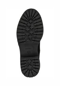Semelle de botte en caoutchouc noir avec des rainures profondes, des motifs en forme de croix et la marque "GEOX" au centre.