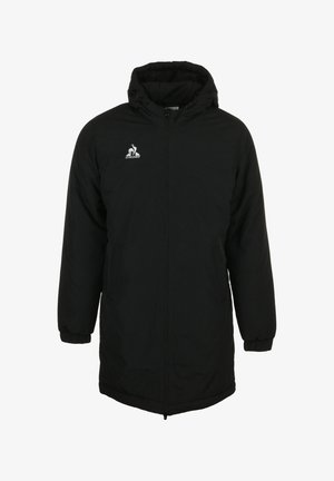 Veste noire matelassée avec fermeture éclair, capuche et poches latérales. Présente un logo blanc sur la poitrine et des poignets élastiques. Texture lisse.
