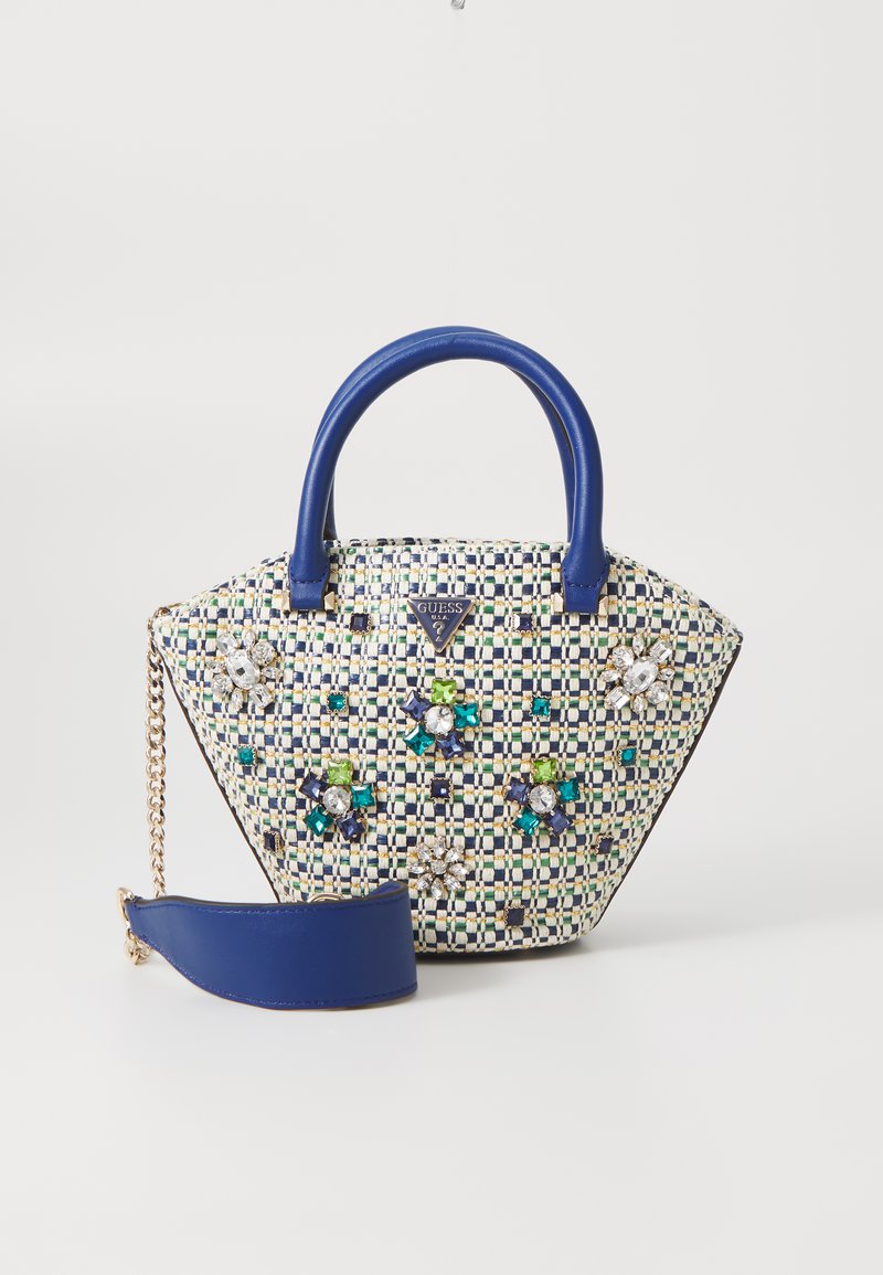 Textured woven handbag in blue and cream with decorative gems in green, blue, and clear. Features two handles and a detachable strap.