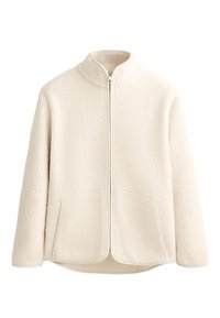 Giacca in pile di colore crema con colletto alto, zip a tutta lunghezza e due tasche laterali. Texture morbida con una superficie esterna strutturata.