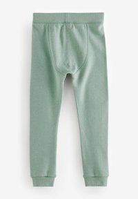 Lichtgroene leggings met een geribbelde textuur en een elastische tailleband. Tapered pasvorm, met omgezoomde uiteinden en een achterpaneel voor extra comfort.