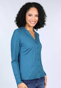 Teal long-sleeve shirt with a v-neck, button closure, and collar. Smooth fabric with a fitted shape and slight stretch.
