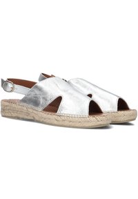 Silver leather espadrilles with cut-out design, rope detailing on the sole, and a buckle strap for adjustable fit.