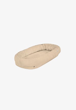 Oval beige cushioned pet bed with raised, padded sides and a soft textured fabric cover.