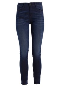 Tajta jeans i mörkblå denim, med hög midja, fem fickor och en slät yta. Subtil blekning längs benen.