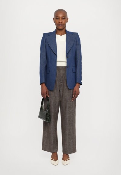 Blue tailored blazer, white textured sweater, brown checkered wide-leg trousers, cream pointed-toe heels, green croc-embossed handbag.