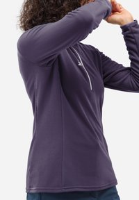Purple long-sleeve base layer top with ribbed texture, half zip, and reflective accent on the collar. Designed for outdoor activities.