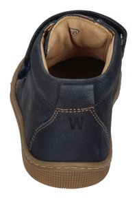 Men's navy leather ankle boot with tan lining, beige sole, and contrasting stitching. Features a round toe and a debossed 'W' logo on the heel.