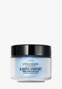 Krem do ciała L'Occitane Karité Confort o ultra-wzbogaconej konsystencji, w niebieskim mlecznym szklanym słoiku z czarną pokrywką, z eleganckim czarnym napisem na etykiecie.