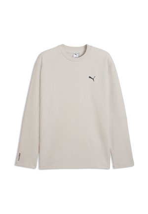 Beige langærmet Puma-shirt med rund halsudskæring og sort Puma-logo på venstre bryst samt lille tekst på venstre ærmekant.