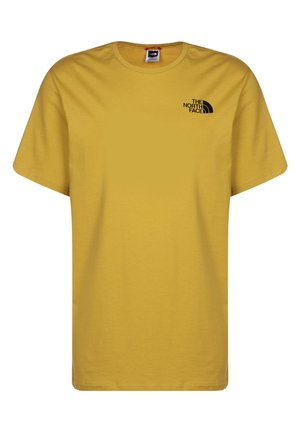 Gelbes Baumwoll-T-Shirt mit rundem Ausschnitt und kurzen Ärmeln. Mit einem kleinen schwarzen Logo auf der Brust. Glatte Textur, legerer Schnitt.