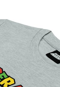 Gray short-sleeve T-shirt with a round neckline and colorful "SUPER MARIO" print. Tag on neck shows "SUPER MARIO" logo. Soft, textured fabric.