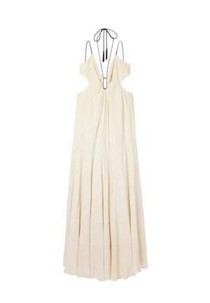 Robe longue couleur crème avec bretelles décolletées, décolleté profond en V, tissu froncé sur le devant et fine attache noire halter dans le dos.