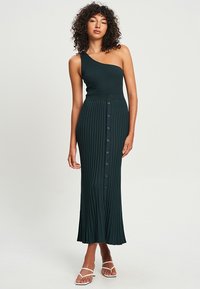 Gestreiftes, dunkelgrünes, einseitiges Kleid mit einem figurbetonten Oberteil und einem langen Rock, der eine Knopfleiste und eine gefältelte Textur aufweist.