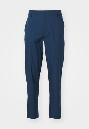 Námornícky modré nohavice s hladkým materiálom, slim fit, predné vrecká a zapínanie na jeden gombík v páse. Bez viditeľných vzorov.