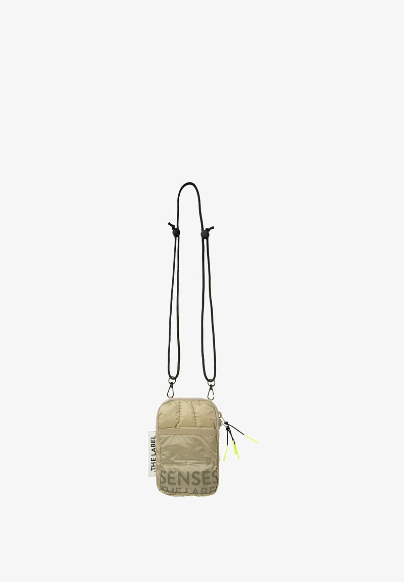 Padded beige crossbody bag with black adjustable straps, featuring a front zipper pocket and neon green accents. Logo printed on the side.
