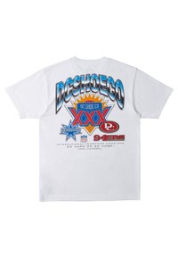 White cotton t-shirt featuring colorful graphics on the back, including "DCSHOECO" in large print, star shapes, and text details.