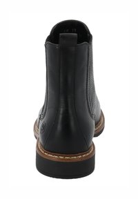 Stivale alla caviglia Chelsea in pelle nera con pannelli laterali elasticizzati, suola cucita marrone, linguetta sul tallone e suola bassa impilata.