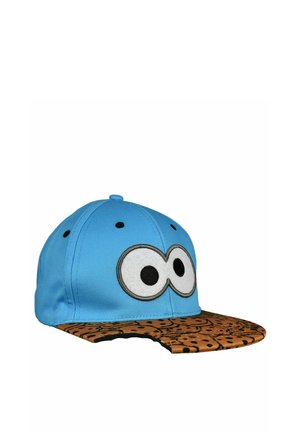 Blue baseball cap with large cartoon eyes on front and a brown patterned brim with a small bite-shaped cutout.