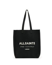 Tote bag noire en tissu résistant affichant le texte "ALLSAINTS" en blanc, avec du texte supplémentaire en japonais, et des sangles d'épaule renforcées.