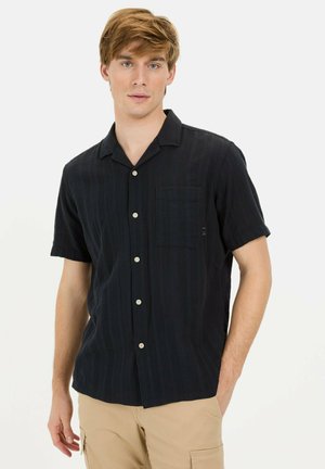 Chemise noire à manches courtes avec un motif rayé texturé, comprenant une poche, un devant à boutons et un col classique.