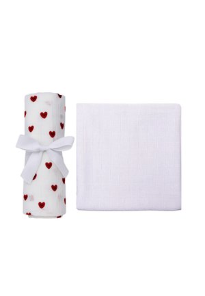 Two white textured cloths, one folded and one rolled with red heart prints and tied with a white ribbon bow.
