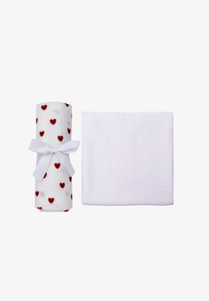 Two white textured cloths, one folded and one rolled with red heart prints and tied with a white ribbon bow.