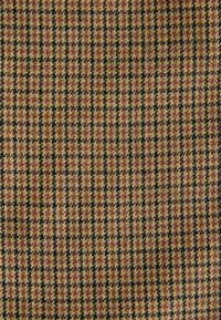 Wool fabric in houndstooth pattern featuring alternating shades of brown, tan, and black, with a textured surface.