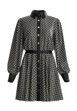 Abito nero con motivo geometrico bianco, apertura con bottoni frontale e colletto nero. Maniche lunghe a sbuffo e dettaglio vita con cintura coordinata.