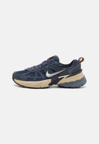 Blaue Mesh-Sneaker mit Wildlederakzenten, ausgestattet mit einer schwarzen und beigen Sohle, strukturiertem Overlay und einem silbernen Logo an der Außenseite.