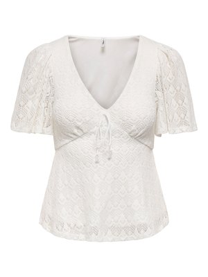 Blusa bianca in pizzo a maniche corte con scollo a V profondo, maniche a sbuffo e un piccolo dettaglio a fiocco sul davanti sotto il seno.