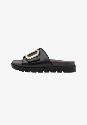 Black slide sandal with thick sole, padded footbed, and large gold buckle on the wide leather strap.