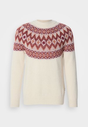 Crewneck-Pullover in Creme mit einem gemusterten Einsatz in Rost und Burgunder. Stricktextur mit gerippten Bündchen und Saum. Kleine Logoakzente sind enthalten.