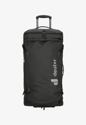 Schwarzer Reisetrage-Rucksack mit ausziehbarem Griff, mehreren Reißverschlussfächern und seitlichen Riemen. Besitzt ein reflektierendes Logo auf der Vorderseite.