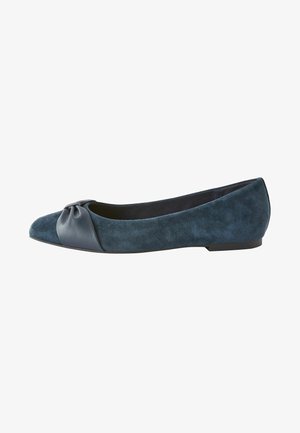 Ballerina piatta in suede blu navy con punta rotonda, accentuata da un rivestimento in pelle liscia nella parte anteriore e un tacco basso e piatto. Morbido al tatto.