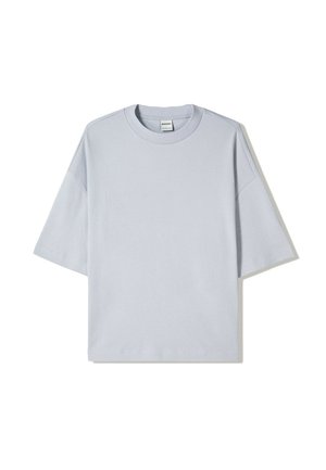 Light blue oversized t-shirt made of cotton, featuring a crew neck, short sleeves, and a plain design with no visible logos or patterns.