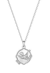 Silver necklace with circular pendant featuring a detailed bird in flight holding a flower in its beak, on a chain link necklace.