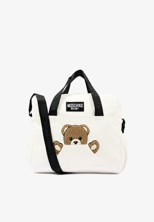 Bolso Moschino Baby blanco con asas y correa negras, con un bolsillo delantero que muestra un oso de peluche marrón bordado asomándose.
