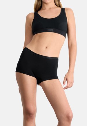 Brassière de sport noire et shorty taille haute en mélange de coton doux. Caractéristiques des bords sans couture et un logo de marque subtil sur la ceinture.