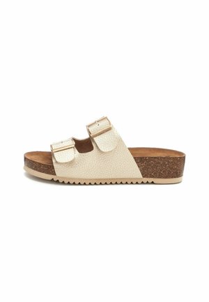 Sandalias de plataforma beige con dos correas ajustables, material texturizado, plantilla de corcho y suela de goma. El diseño cuenta con un toe abierto y plano.