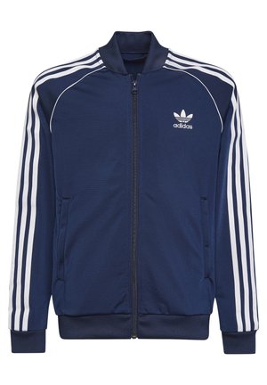 Veste de survêtement Adidas bleu marine avec trois bandes blanches sur les manches, fermeture éclair intégrale à l'avant et logo Adidas sur la poitrine.
