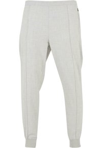 Lichtgrijze joggers van zacht materiaal, met een elastische tailleband, cuffed enkels en zijzakken met een subtiele textuur.