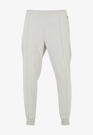 Világosszürke joggerek, puha anyagból, rugalmas derékkal, cipzáros bokákkal, oldalzsebekkel és egy finom textúrával.