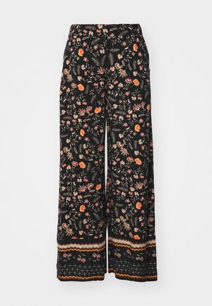 Black floral wide-leg pants feature a colorful pattern of flowers and leaves. The hem has a striped design in orange, brown, and cream.