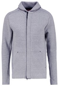Sweat-shirt gris clair zippé intégral avec col montant et deux poches avant, en tissu doux chiné.