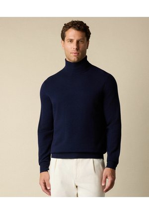 Pull à col roulé bleu marine en tricot doux, avec des manches longues et une coupe ajustée. Texture lisse avec des poignets et un ourlet côtelés.