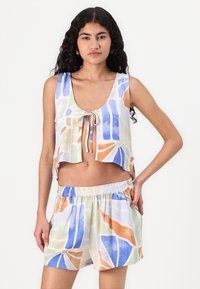 Cropped, sleeveless top and shorts set in soft fabric. Features abstract patterns in blue, orange, and green on a light background.